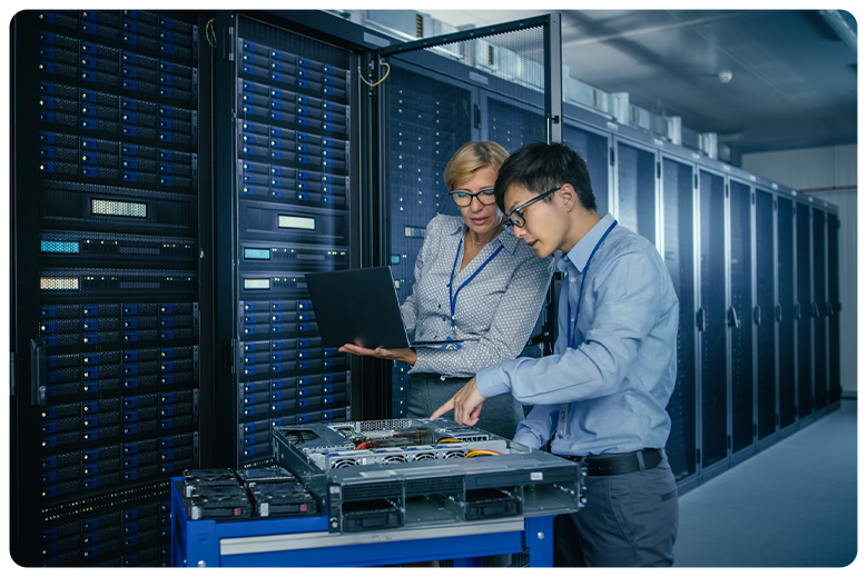 two engineers in a data center discussing
